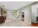 Hallway with neutral carpet, white trim, and a view into the laundry room and bedroom at 635 Wilson Nw Rd, Atlanta, GA 30318
