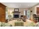 Cozy living room with a stone fireplace, plush seating, and ample natural light at 635 Wilson Nw Rd, Atlanta, GA 30318