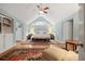 A bright primary bedroom featuring vaulted ceiling, wooden floors, and a decorative rug at 635 Wilson Nw Rd, Atlanta, GA 30318