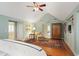 A relaxing primary suite with hardwood floors, ensuite bathroom, seating area, and natural light at 635 Wilson Nw Rd, Atlanta, GA 30318