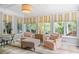 Bright sunroom with three large windows, stylish window treatments, and comfortable seating at 635 Wilson Nw Rd, Atlanta, GA 30318