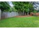 Large grassy back yard with a wooden fence and play set at 1217 Club Walk Ne Dr, Brookhaven, GA 30319