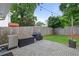 Landscaped backyard featuring a paved patio area with a built-in grill and a privacy fence at 1217 Club Walk Ne Dr, Brookhaven, GA 30319