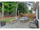Backyard patio area with string lights and an adjacent yard area featuring a swing set at 1217 Club Walk Ne Dr, Brookhaven, GA 30319