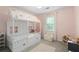 Charming pink bedroom with a decorative canopy bed and carpeted floors at 1217 Club Walk Ne Dr, Brookhaven, GA 30319