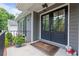 Inviting front porch with double doors, stylish decor, and lush greenery enhancing the entrance at 1217 Club Walk Ne Dr, Brookhaven, GA 30319