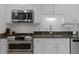 Well-equipped kitchen with stainless steel appliances, granite countertops, and custom white cabinetry at 1217 Club Walk Ne Dr, Brookhaven, GA 30319