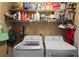 Well-equipped laundry room includes front loading washer and dryer with lots of shelving for storage at 1217 Club Walk Ne Dr, Brookhaven, GA 30319