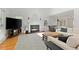Spacious living room with a fireplace, hardwood floors, and large windows offering abundant natural light at 1217 Club Walk Ne Dr, Brookhaven, GA 30319