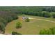 An aerial view of a home showcases a well-maintained yard and private location at 1423 Hillcrest Rd, Bowdon, GA 30108
