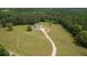 An aerial view showcases the home on a large lot with an expansive driveway at 1423 Hillcrest Rd, Bowdon, GA 30108