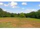 A spacious backyard offers plenty of room to play and enjoy the outdoors at 1423 Hillcrest Rd, Bowdon, GA 30108