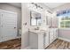Bright and spacious bathroom with double vanities, granite countertops, and modern lighting at 1423 Hillcrest Rd, Bowdon, GA 30108