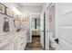 Spacious bathroom with marble countertops, white cabinets, and access to the bedroom at 1423 Hillcrest Rd, Bowdon, GA 30108