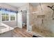 Modern bathroom with a frameless glass shower and sliding barn door into the toilet area at 1423 Hillcrest Rd, Bowdon, GA 30108