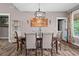 Comfortable dining room featuring a large table, stylish chandelier, and access to the backyard at 1423 Hillcrest Rd, Bowdon, GA 30108