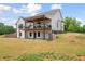 A lovely two-story home features a charming covered outdoor deck and well-maintained backyard landscaping at 1423 Hillcrest Rd, Bowdon, GA 30108