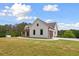 Lovely home showcasing vertical siding, a covered front porch, an attached garage, and a spacious front yard at 1423 Hillcrest Rd, Bowdon, GA 30108