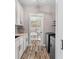 Well-equipped laundry room with white cabinets, modern appliances, and stylish wood-look flooring at 1423 Hillcrest Rd, Bowdon, GA 30108