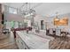 Open-concept living space with hardwood floors, brick fireplace, and contemporary lighting fixtures at 1423 Hillcrest Rd, Bowdon, GA 30108