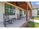 Charming covered front porch with black rocking chairs and a wooden ceiling, perfect for relaxing and enjoying the outdoors at 1423 Hillcrest Rd, Bowdon, GA 30108