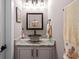 Stylish powder room featuring a decorative sink, granite countertop, and elegant fixtures at 1423 Hillcrest Rd, Bowdon, GA 30108