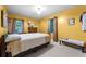 Bedroom features a queen bed, carpeted floor, and bright yellow walls at 2237 Walt Stephens Rd, Jonesboro, GA 30236