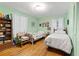 Bedroom with hardwood floors, mint green walls, and two twin beds at 2237 Walt Stephens Rd, Jonesboro, GA 30236