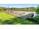 Long wooden dock extends into the water, complemented by lush green grass and mature trees in the background at 2237 Walt Stephens Rd, Jonesboro, GA 30236