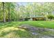 The front of this cozy home offers ample yard space, a covered patio, and plenty of parking at 2237 Walt Stephens Rd, Jonesboro, GA 30236