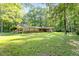 Well-maintained home with a covered parking area, set on a spacious lot with lush greenery at 2237 Walt Stephens Rd, Jonesboro, GA 30236
