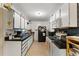 Functional kitchen with ample cabinet space, a mix of black and white appliances, and tile flooring at 2237 Walt Stephens Rd, Jonesboro, GA 30236