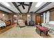Open living room with a fireplace, beamed ceiling, neutral carpet and panelled walls that gives a cozy feel at 2237 Walt Stephens Rd, Jonesboro, GA 30236
