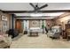 Cozy living room with a brick accent wall, wood-burning stove, plush seating, and a ceiling fan at 2237 Walt Stephens Rd, Jonesboro, GA 30236