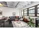 Cozy living room with black painted floor, large windows, and a comfortable gray sofa at 878 Peachtree Ne St # 634, Atlanta, GA 30309