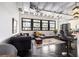 Sunlit living room featuring exposed ceilings, modern decor, and a view of the bedroom space at 878 Peachtree Ne St # 634, Atlanta, GA 30309
