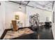 Open concept office space with dark floors, contemporary shelving, and an area rug at 878 Peachtree Ne St # 634, Atlanta, GA 30309