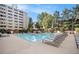 Large swimming pool with surrounding lounge chairs, landscaping, and towering condominium buildings at 878 Peachtree Ne St # 634, Atlanta, GA 30309