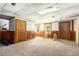 Finished basement area with paneled walls, carpeted flooring, and natural light from the above ground windows at 1956 Spencer Oaks Ln, Lithonia, GA 30058
