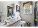 Well-lit bathroom with a single sink vanity, toilet, and shower with curtain at 1956 Spencer Oaks Ln, Lithonia, GA 30058