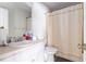 Simple bathroom featuring a single sink vanity, toilet, and shower with neutral curtain at 1956 Spencer Oaks Ln, Lithonia, GA 30058