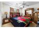 Cozy bedroom with a floral-themed bedspread, matching bedside tables, and natural light at 1956 Spencer Oaks Ln, Lithonia, GA 30058