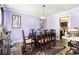 Formal dining room with wood floors, seating for six, and modern decor at 1956 Spencer Oaks Ln, Lithonia, GA 30058