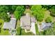 Bird's-eye view of a house with a well-maintained yard, driveway, and mature trees around the property at 2370 Burch Cir, Brookhaven, GA 30319