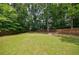 Fenced backyard with lush green grass and mature trees at 2370 Burch Cir, Brookhaven, GA 30319