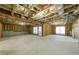 Spacious unfinished basement with exposed insulation, concrete flooring, and natural light through windows and door at 2370 Burch Cir, Brookhaven, GA 30319
