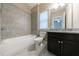 Tiled bathroom with combo tub and shower at 2370 Burch Cir, Brookhaven, GA 30319