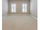 Bright, carpeted bedroom with plenty of natural light from two windows at 2370 Burch Cir, Brookhaven, GA 30319