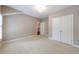 Neutral bedroom featuring an ensuite bathroom and a double door closet at 2370 Burch Cir, Brookhaven, GA 30319