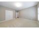 Neutral bedroom with plush carpeting and a double door closet at 2370 Burch Cir, Brookhaven, GA 30319